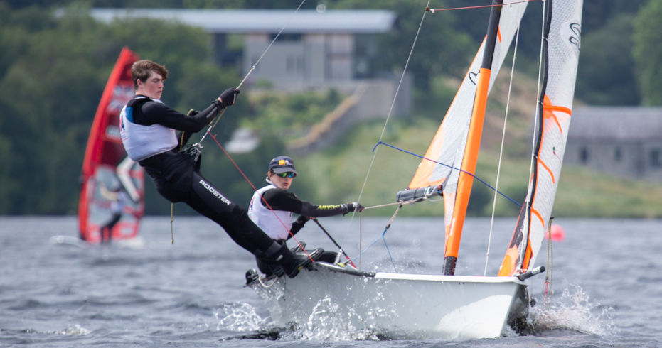 Long shot of two female sailors steering dinghy