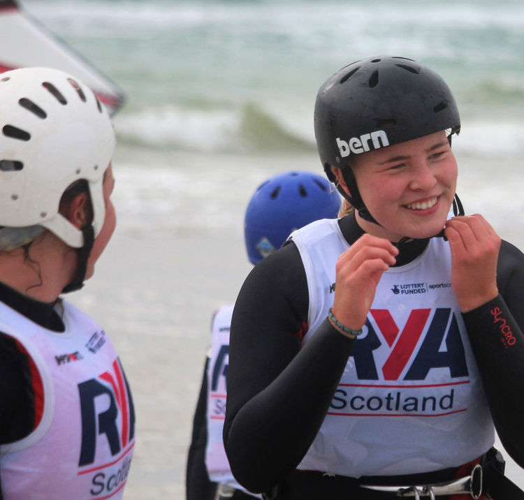 Mid shot of sailor clipping on helmet